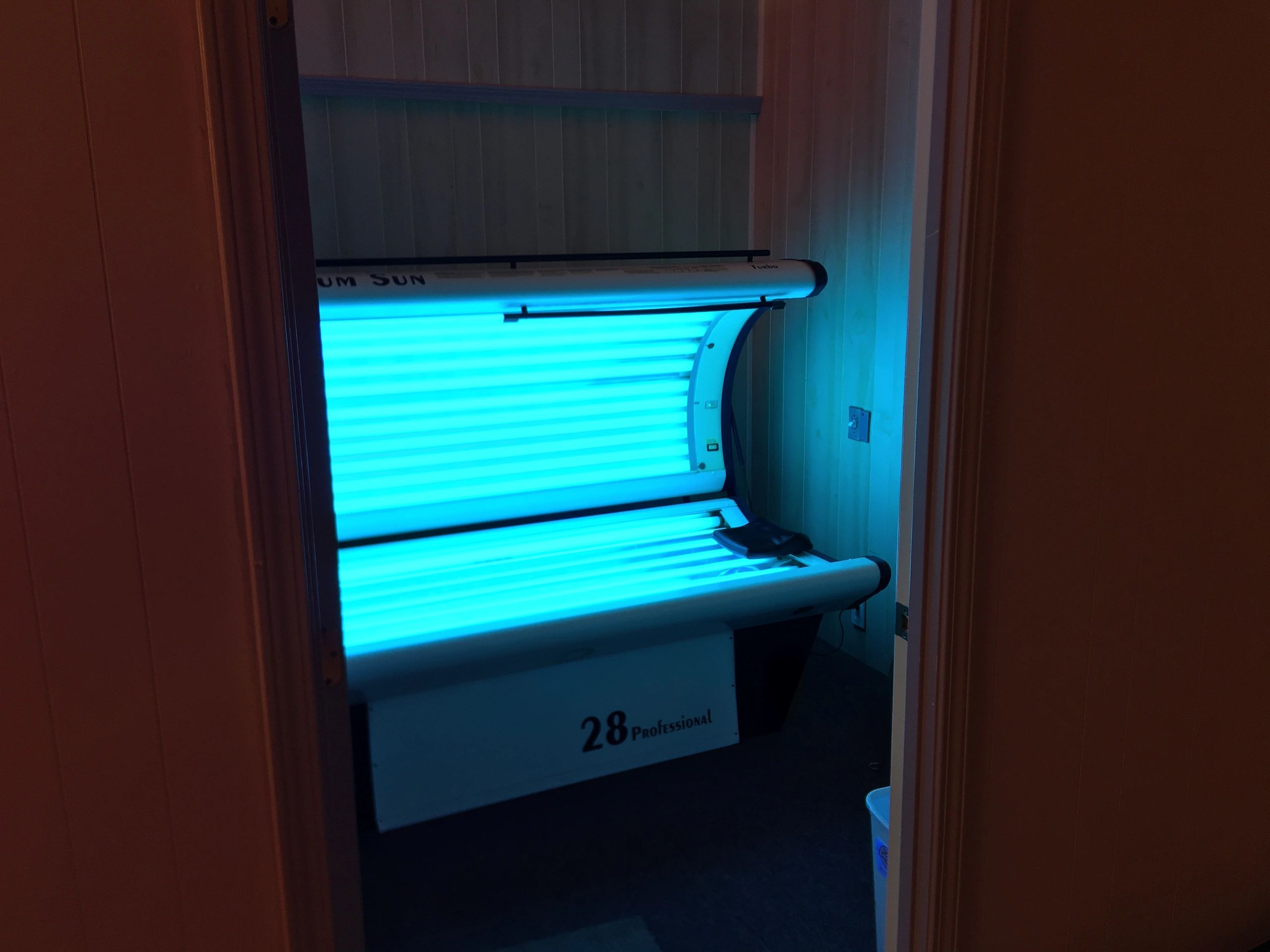 open tanning bed with blue light